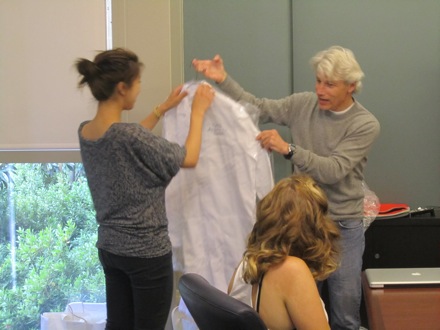Dr. Goldberg presents white coat to Pauline at Final Symposium.